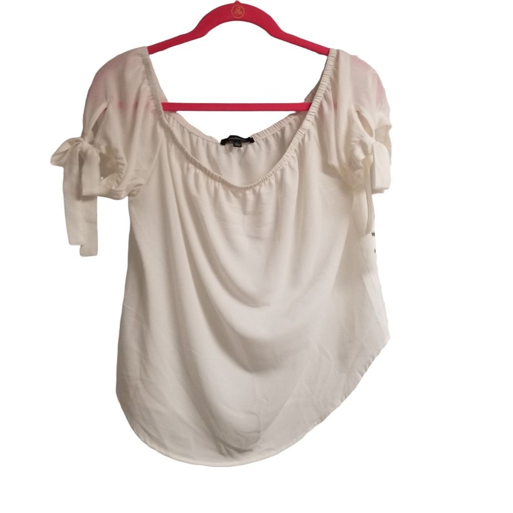 Ambiance white blouse with ties on sleeves.